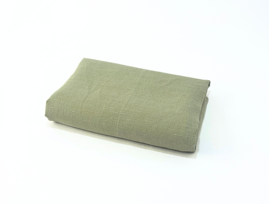 Folded green fabric on a white background