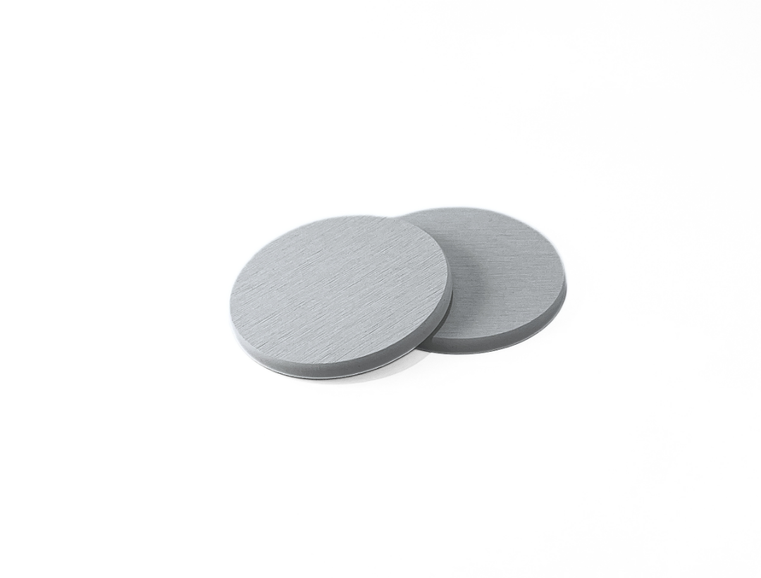 Two gray circular coasters on a white background