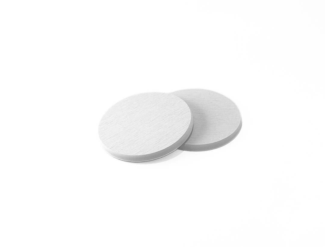 Two white circular coasters on a white background