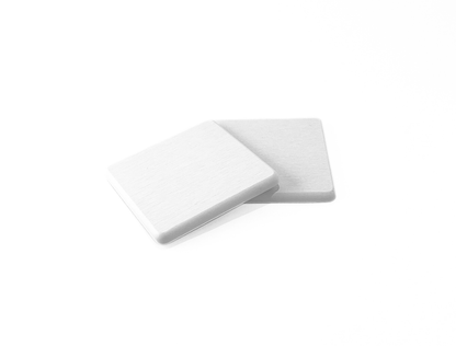 Two white square coasters on a white background