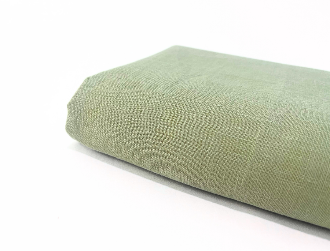 Green linen towel on a white background
