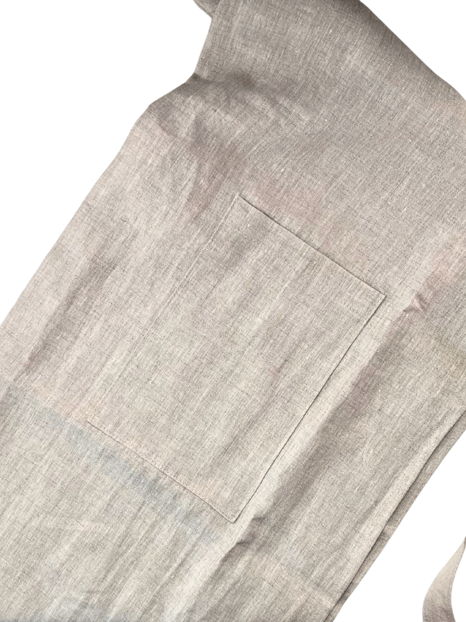 Close-up of a gray apron with a pocket on a white background