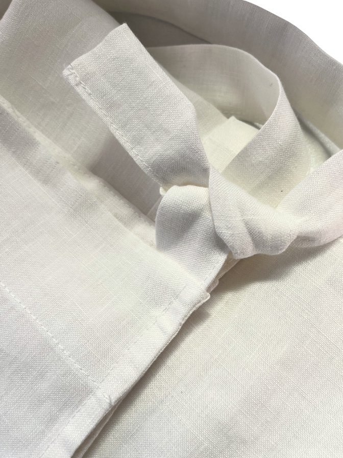 Close-up of a light beige apron on a light background
