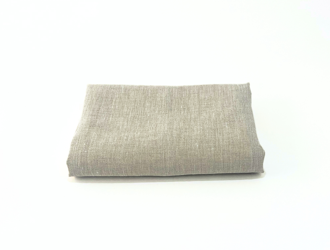 Folded gray linen towel on a white background