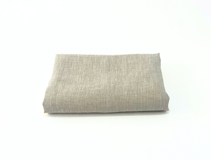 Folded gray linen towel on a white background